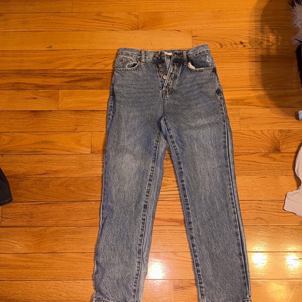 Pascun thrifted jeans that are blue and are straight legged with buttons